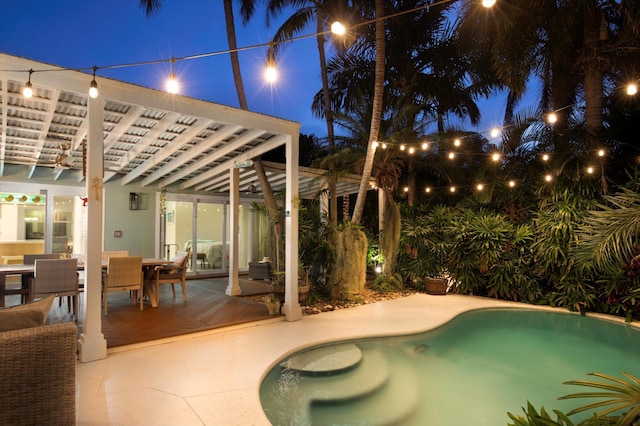 pool at twilight featuring a pergola and a patio area