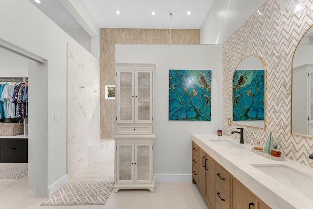 bathroom with backsplash, vanity, and a tile shower