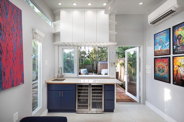 bar featuring wine cooler, a wall mounted air conditioner, sink, and light tile patterned floors