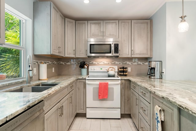 217 Gasparilla Dr, Key Largo, FL 33037 - kitchen featuring appliances with stainless steel finishes, recessed lighting, decorative backsplash, light stone countertops, and decorative light fixtures
