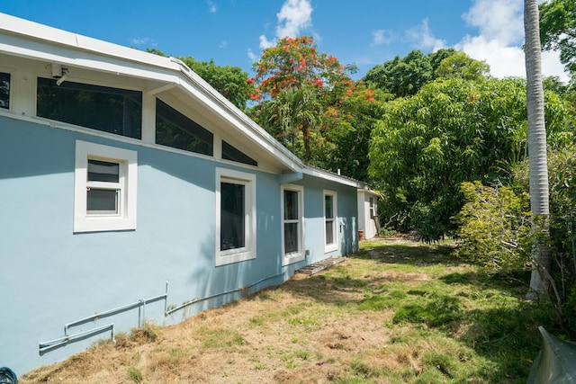 217 Gasparilla Dr, Key Largo, FL 33037 - view of home's exterior with stucco siding and a lawn