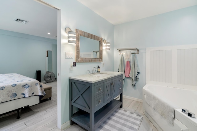 217 Gasparilla Dr, Key Largo, FL 33037 - full bath featuring a bath, vanity, wood finished floors, and recessed lighting
