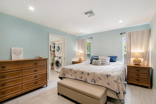 217 Gasparilla Dr, Key Largo, FL 33037 - bedroom with stacked washing machine and dryer, recessed lighting, and light wood-style floors