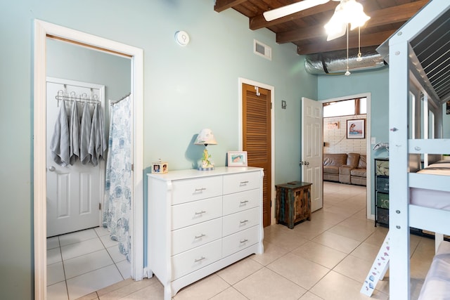 217 Gasparilla Dr, Key Largo, FL 33037 - bedroom with light tile patterned flooring and a wood ceiling with exposed beams