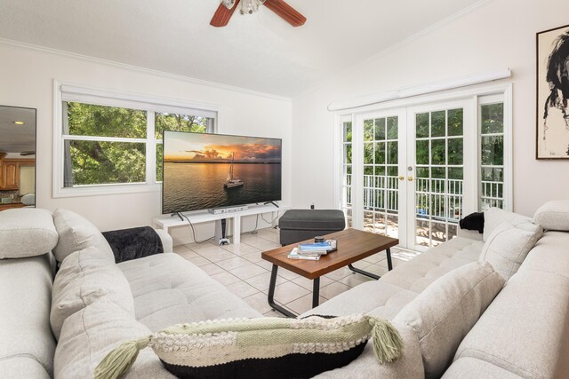 living room featuring vaulted ceiling, light tile patterned floors, ceiling fan, crown molding, and french doors