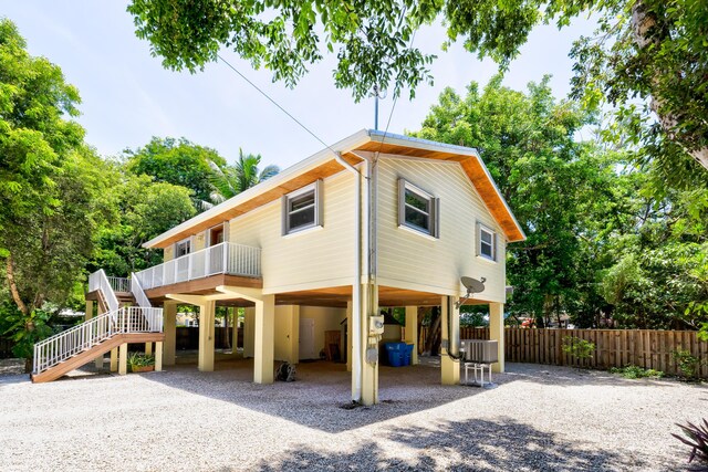 view of front of property with a carport and central AC unit