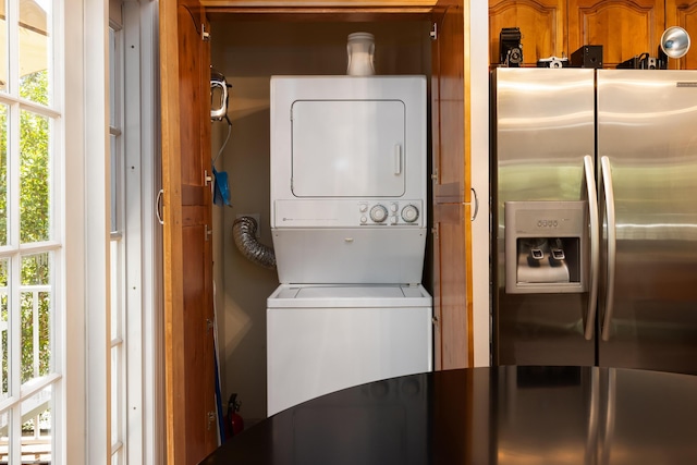 washroom featuring stacked washer and clothes dryer