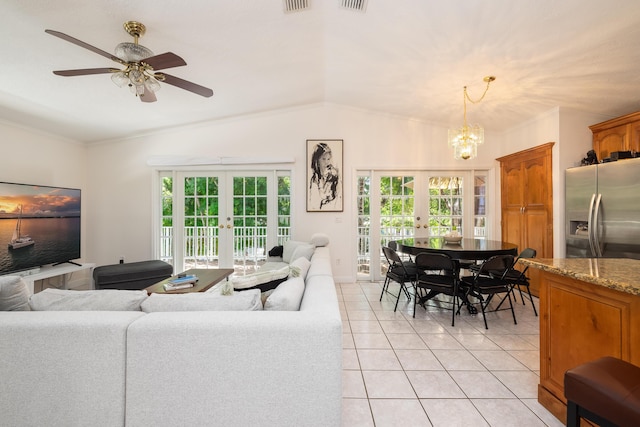 tiled living room featuring lofted ceiling, ceiling fan with notable chandelier, ornamental molding, and french doors