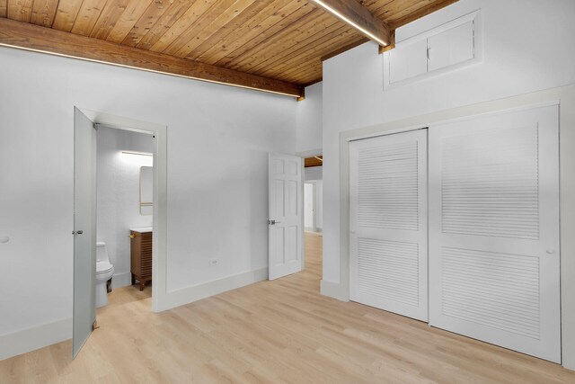 178 Coral Ave, Tavernier, FL 33070 - unfurnished bedroom featuring a wood ceiling with exposed beams, wood finished floors, a closet, and connected bathroom