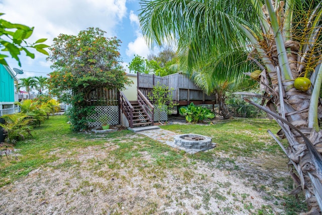 30957 Mercedes Rd, Big Pine, FL 33043 - view of yard featuring a fire pit, stairway, and a wooden deck
