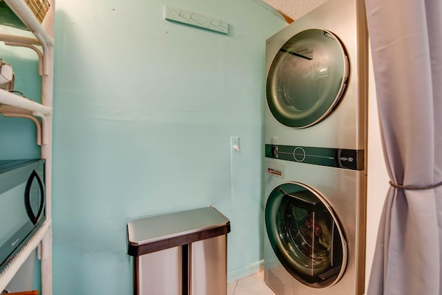30957 Mercedes Rd, Big Pine, FL 33043 - laundry area with stacked washer and clothes dryer and tile patterned floors
