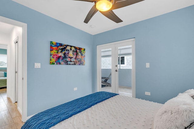 bedroom featuring french doors, ceiling fan, multiple windows, and light wood-type flooring