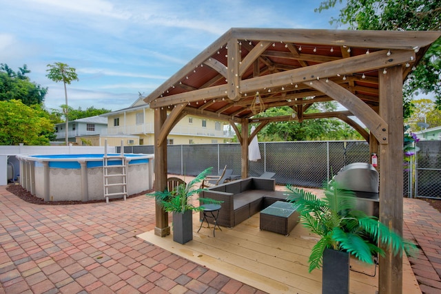 view of patio / terrace with a gazebo, outdoor lounge area, and a swimming pool side deck