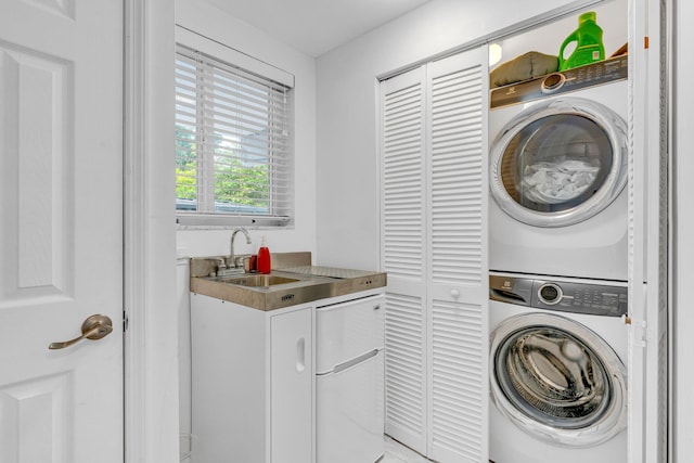 washroom featuring stacked washer and dryer and sink