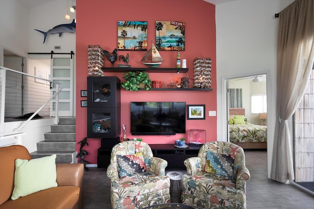 living room with dark wood-type flooring and a barn door