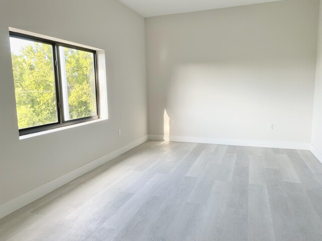 unfurnished room with light hardwood / wood-style floors