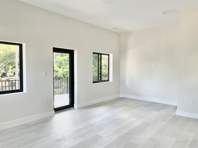 spare room featuring light hardwood / wood-style flooring