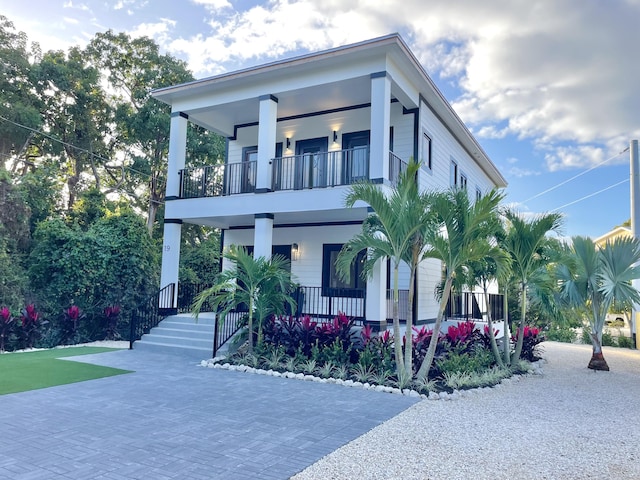 view of front of house with a balcony and covered porch