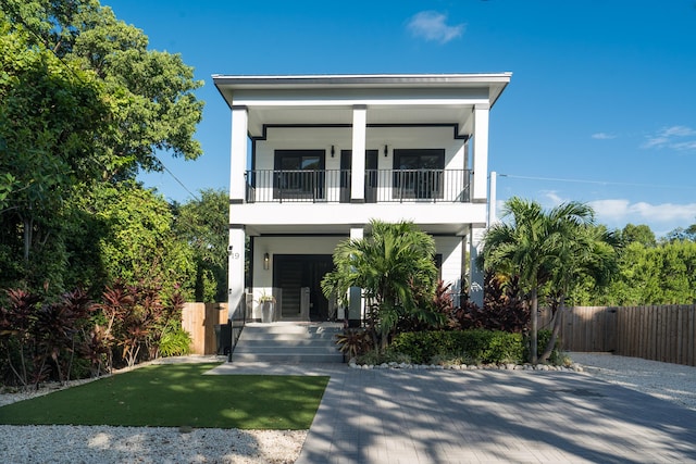 coastal home with a balcony and covered porch