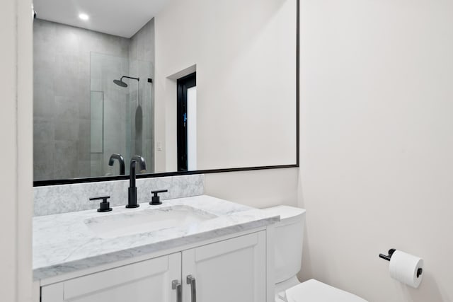 bathroom featuring vanity, toilet, and an enclosed shower