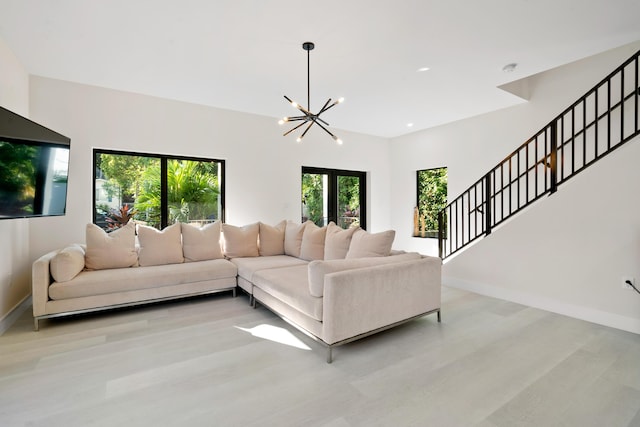 living room featuring an inviting chandelier and light wood-type flooring