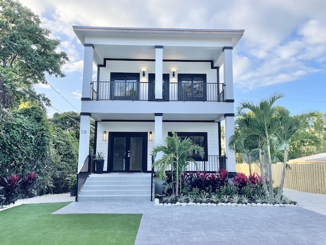 contemporary home with a balcony and french doors