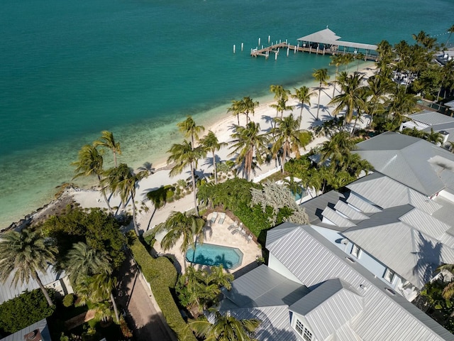 birds eye view of property featuring a water view and a beach view