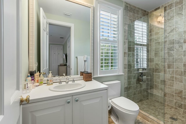 bathroom featuring vanity, toilet, and a shower with door