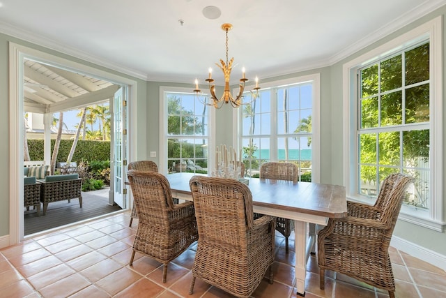 tiled dining room with crown molding, a wealth of natural light, and an inviting chandelier