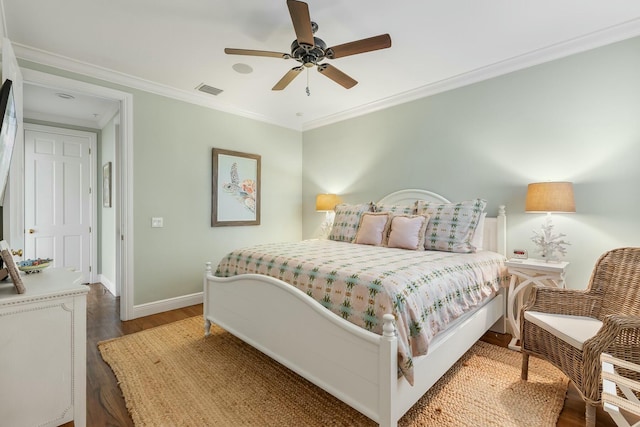 bedroom with ceiling fan, ornamental molding, and dark hardwood / wood-style flooring