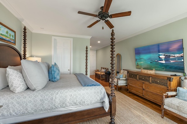 bedroom with crown molding, hardwood / wood-style flooring, and ceiling fan