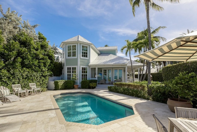 rear view of property featuring french doors and a patio