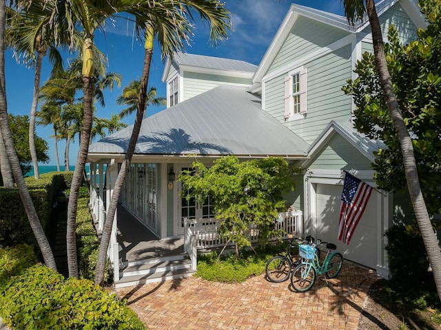 back of house featuring covered porch