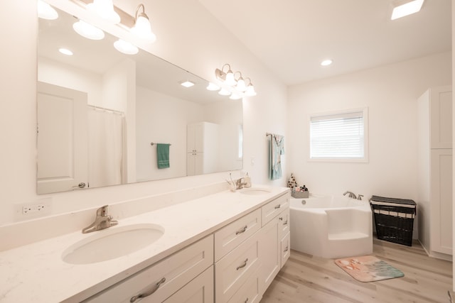 bathroom with vanity, wood-type flooring, and plus walk in shower