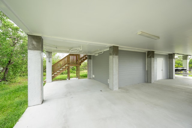 view of patio / terrace featuring a garage and a carport