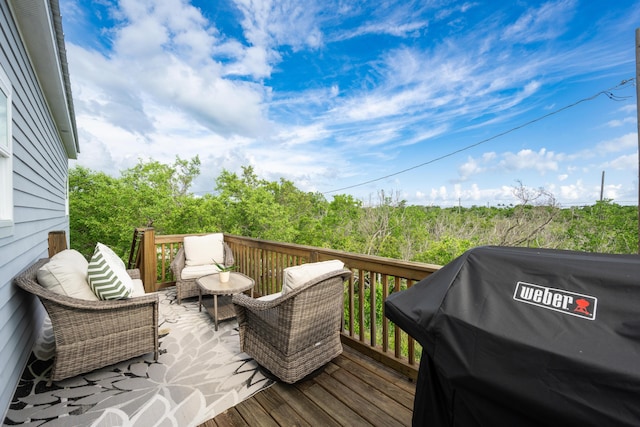 deck featuring a grill and an outdoor living space