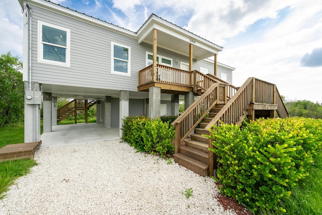 coastal inspired home featuring a carport and covered porch