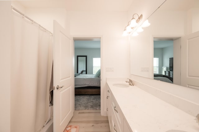 bathroom featuring hardwood / wood-style flooring, vanity, and curtained shower