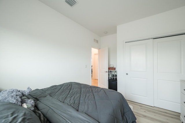 bedroom featuring a closet and light wood-type flooring