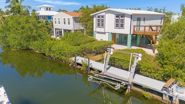 rear view of property with a water view