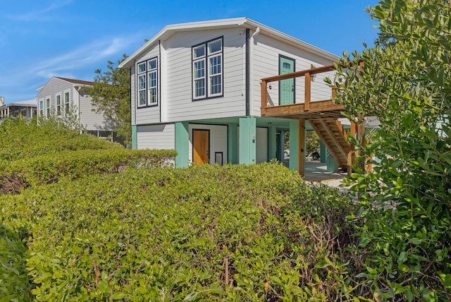 back of house featuring a deck