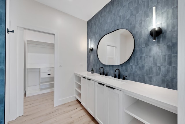 bathroom with vanity, hardwood / wood-style flooring, and tile walls