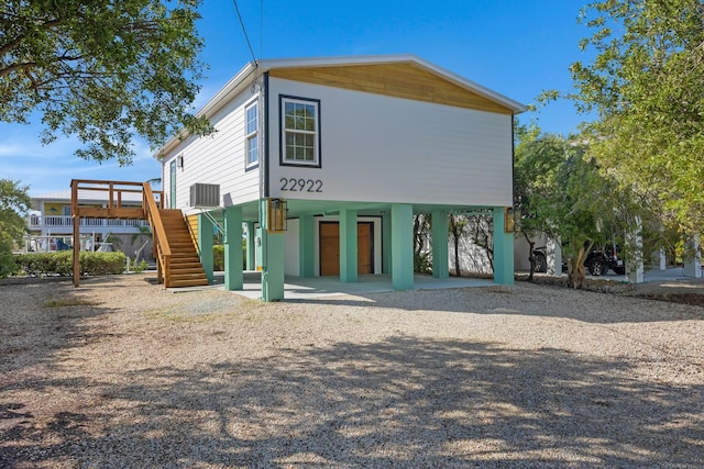 rear view of property with a patio area and central air condition unit