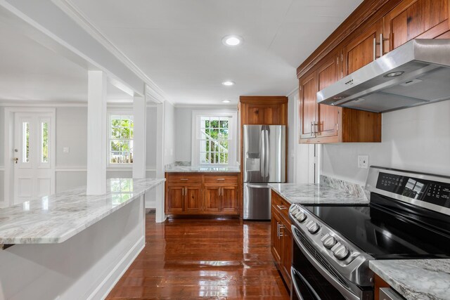 kitchen featuring dark hardwood / wood-style flooring, light stone countertops, stainless steel appliances, and exhaust hood