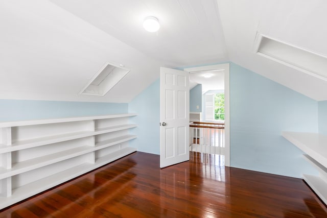 bonus room featuring dark wood-type flooring and lofted ceiling