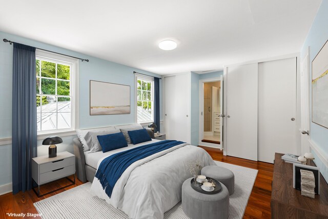 bedroom with dark hardwood / wood-style floors