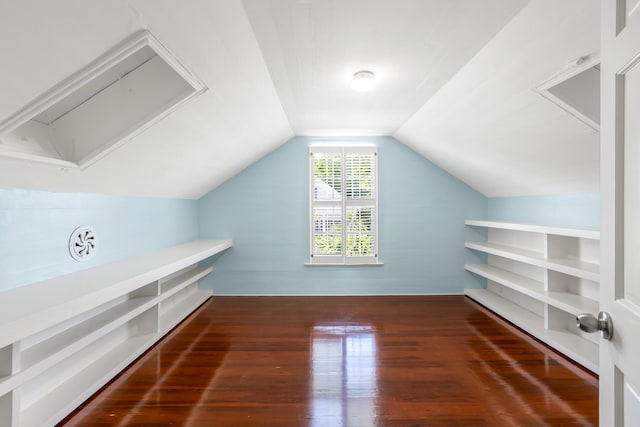 bonus room with lofted ceiling and dark hardwood / wood-style flooring