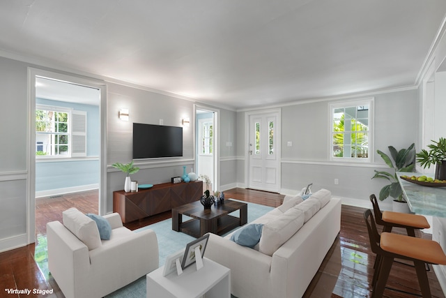 living room with dark wood-type flooring and ornamental molding