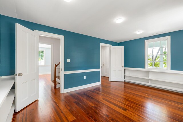 unfurnished bedroom featuring dark hardwood / wood-style flooring