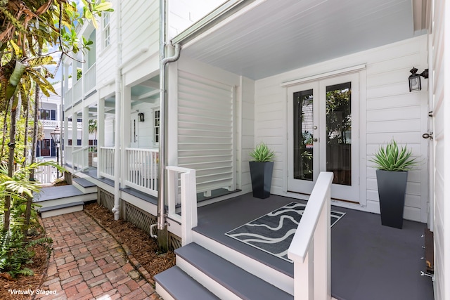 exterior space featuring a porch and french doors